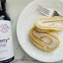 elderberry cake roll with a bottle of elderberry syrup